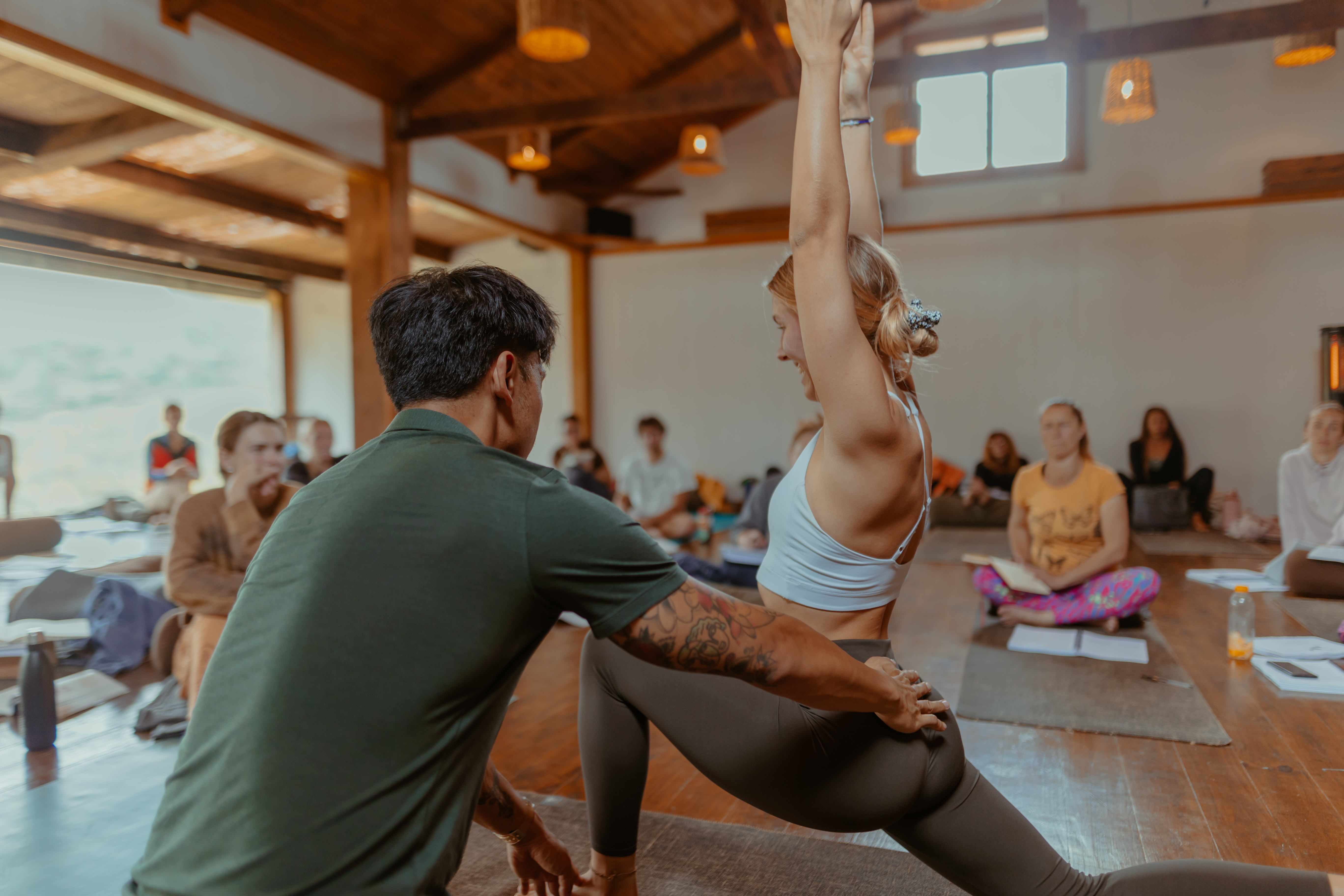 Bruce adjusting a student during a yoga teacher training